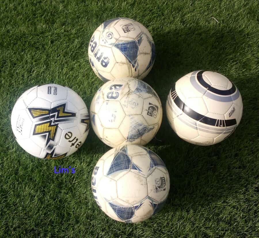Ballons de football posés sur la pelouse